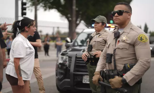 Protesters confront law enforcement agents outside an industrial park in Paramount section of Los Angeles on Saturday, June 7, 2025 (AP Photo/Eric Thayer)