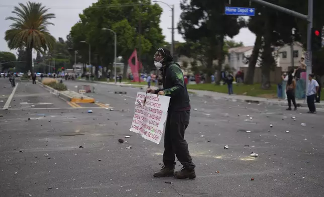 Protesters confront Border Patrol personnel during a demonstration over the dozens detained in an operation by federal immigration authorities a day earlier in Paramount section of Los Angeles Saturday, June 7, 2025. (AP Photo/Eric Thayer)