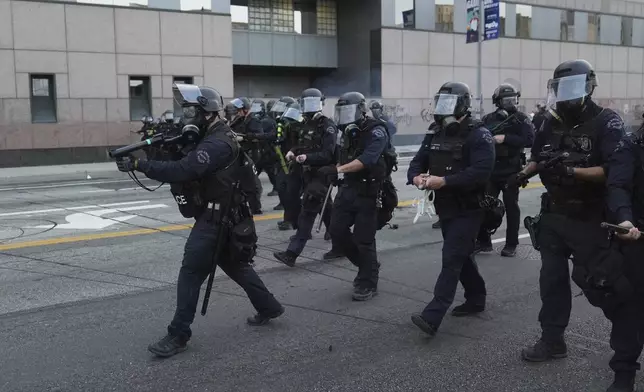 Los Angeles Police Department officers move to disperse a protest after federal immigration authorities conducted an operation on Friday, June 6, 2025, in Los Angeles. (AP Photo/Jae C. Hong)