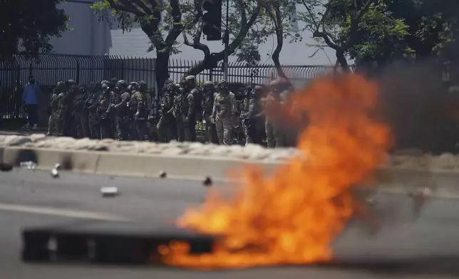 Law enforcement stand during a protest in the Paramount section of Los Angeles, Saturday, June 7, 2025, after federal immigration authorities conducted operations. (AP Photo/Eric Thayer)
