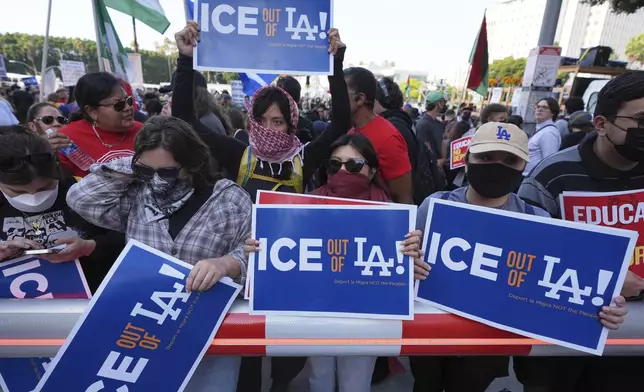 Protesters gather after federal immigration authorities conducted an operation on Friday, June 6, 2025, in Los Angeles. (AP Photo/Damian Dovarganes)