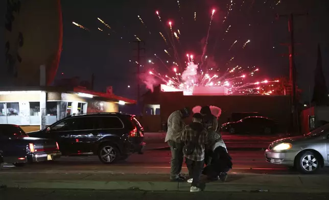 Protesters attempt to light a Molotov cocktail as a firework explodes during a protest in Compton, Calif., Saturday, June 7, 2025, after federal immigration authorities conducted operations. (AP Photo/Ethan Swope)
