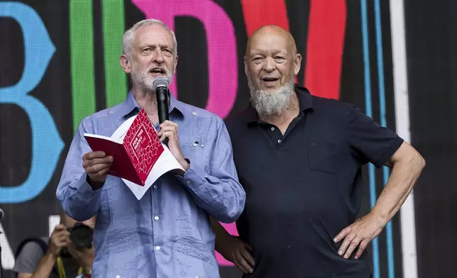 FILE - Britain's Labour Party leader Jeremy Corbyn, left, and organizer Michael Eavis appear onstage at the Glastonbury Festival at Worthy Farm, in Somerset, England, June 24, 2017. (Photo by Grant Pollard/Invision/AP, file)