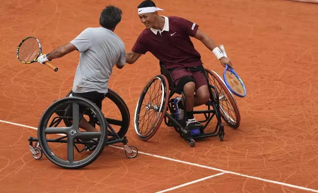 Japan's Tokito Oda, right, celebrate with France's Stephane Houdet as they won against Netherlands' Tom Egberink and Belgium's Joachim Gerard at the wheelchair doubles quarterfinal match of the French Tennis Open at the Roland-Garros stadium in Paris, Wednesday, June 4, 2025. (AP Photo/Lindsey Wasson)