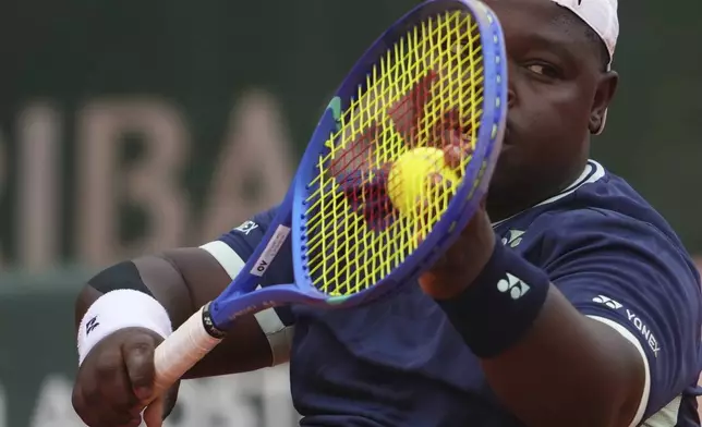 South Africa's Donald Ramphadi serves against Netherlands' Sam Schroder during their wheelchair singles quarterfinal match of the French Tennis Open at the Roland-Garros stadium in Paris, Wednesday, June 4, 2025. (AP Photo/Lindsey Wasson)