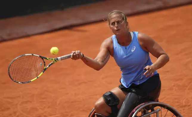 France's Pauline Deroulede plays a shot against Japan's Yui Kamiji during their women's wheelchair singles first round match of the French Tennis Open at the Roland-Garros stadium in Paris, Tuesday, June 3, 2025. (AP Photo/Aurelien Morissard)