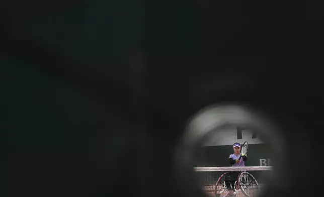 Japan's Manami Tanaka serves against Netherlands' Aniek Van Koot during their women's wheelchair singles quarterfinal match of the French Tennis Open at the Roland-Garros stadium in Paris, Thursday, June 5, 2025. (AP Photo/Lindsey Wasson)