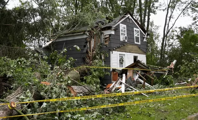 A home in Clark Mills, N.Y., that had a tree fall through it during a severe storm in the early morning, Sunday, June 22, 2025. (Tom Connolly/Spectrum News via AP)
