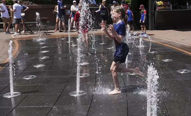 Jude Puroway cools off at a fountain during hot weather in Chicago, Sunday, June 22, 2025. (AP Photo/Nam Y. Huh)