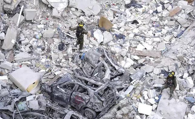 Israeli soldiers search for survivors amid the rubble of residential buildings destroyed by an Iranian missile strike in Bat Yam, central Israel, on Sunday, June 15, 2025. (AP Photo/Ariel Schalit)
