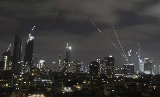 The Israeli Iron Dome air defense system fires to intercept missiles over Tel Aviv, Israel, Sunday, June 15, 2025. (AP Photo/Leo Correa)