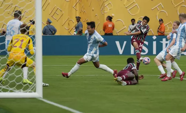 Fluminense's German Cano (14) makes a cross pass to Juan Pablo Freytes during the second half of a Club World Cup group F soccer match against Ulsan HD, Saturday, June 21, 2025, in East Rutherford, N.J. (AP Photo/Seth Wenig)