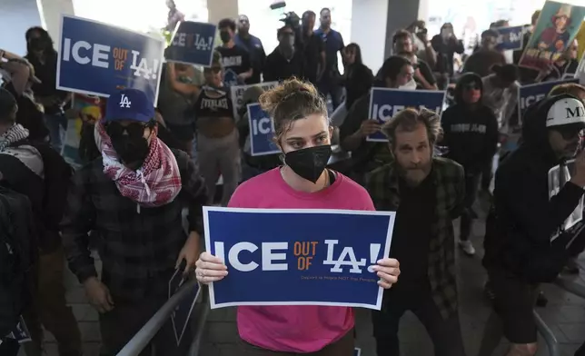 FILE - Protesters gather at the U.S. Department of Justice Federal Bureau of Prisons after federal immigration authorities conducted an operation on Friday, June 6, 2025, in Los Angeles. (AP Photo/Jae C. Hong, File)