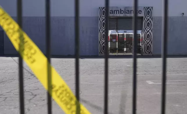 FILE - Caution tape hangs outside Ambiance Apparel after federal immigration authorities conducted an operation on Friday, June 6, 2025, in Los Angeles. (AP Photo/Jae C. Hong, File)
