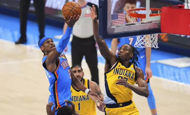Oklahoma City Thunder guard Shai Gilgeous-Alexander (2) shoots against Indiana Pacers forward Aaron Nesmith (23) during the second half of Game 2 of the NBA Finals basketball series Sunday, June 8, 2025, in Oklahoma City. (AP Photo/Kyle Phillips)