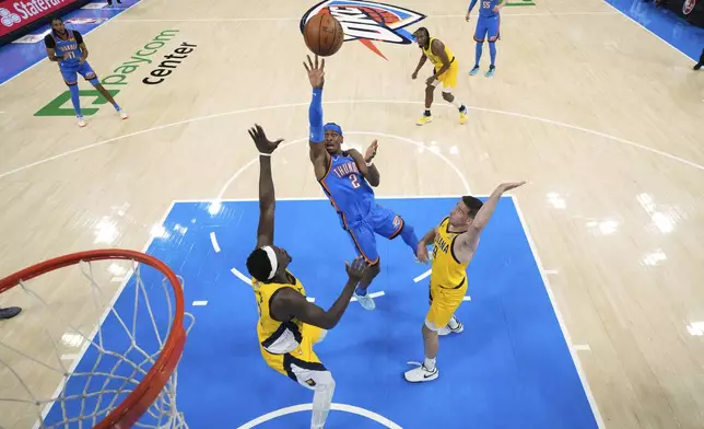 Oklahoma City Thunder guard Shai Gilgeous-Alexander (2) shoots against Indiana Pacers forward Pascal Siakam (43) and guard T.J. McConnell (9) during the first half of Game 2 of the NBA Finals basketball series Sunday, June 8, 2025, in Oklahoma City. (Matthew Stockman/Pool Photo via AP)