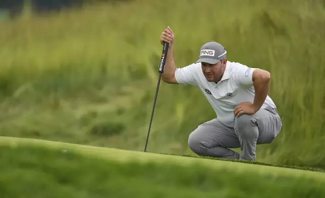 Thriston Lawrence, of South Africa, lines up a putt on the 12th hole during the second round of the U.S. Open golf tournament at Oakmont Country Club Friday, June 13, 2025, in Oakmont, Pa. (AP Photo/Seth Wenig)