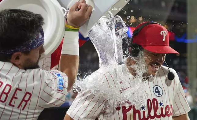 Philadelphia Phillies' Otto Kemp, right, is dunked by Kyle Schwarber after the Phillies won a baseball game against the Chicago Cubs Monday, June 9, 2025, in Philadelphia. (AP Photo/Matt Slocum)
