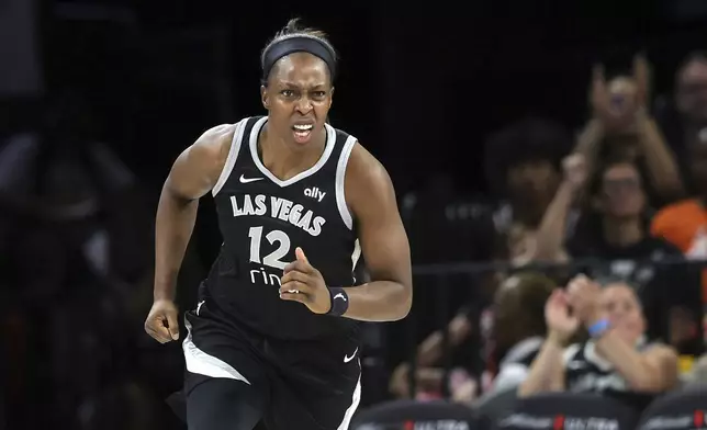 Las Vegas Aces guard Chelsea Gray (12) reacts after scoring a basket against the Phoenix Mercury during the first half of an WNBA basketball game Sunday, June 15, 2025, in Las Vegas. (Steve Marcus/Las Vegas Sun via AP)
