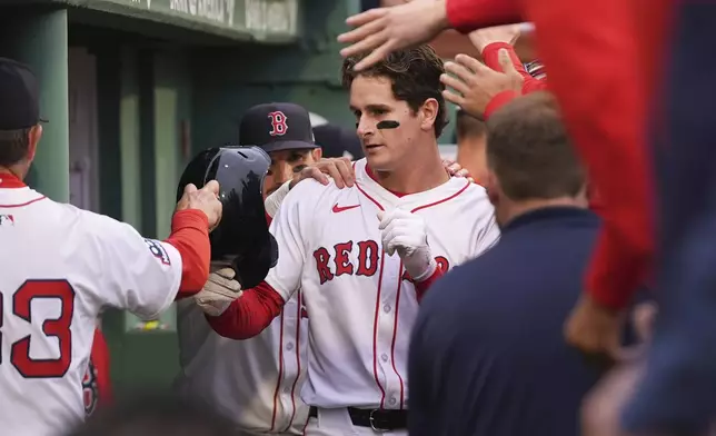 Boston Red Sox rookie Roman Anthony is congratulated after his two RBI double, his first major league hit, after the first inning of a baseball game against the Tampa Bay Rays at Fenway Park, Tuesday, June 10, 2025, in Boston. (AP Photo/Charles Krupa)