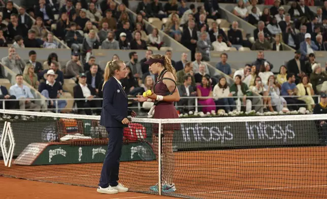 Russia's Mirra Andreeva, right, speaks with umpire Miriam Bley during the quarterfinal match of the French Tennis Open against France's Lois Boisson at the Roland-Garros stadium in Paris, Wednesday, June 4, 2025. (AP Photo/Aurelien Morissard)
