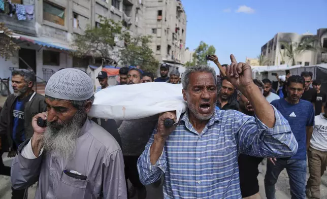 Palestinians carry Reem Al-Akhras, who was killed while heading to an aid distribution hub, during her funeral in Khan Younis, Gaza Strip, Tuesday, June 3, 2025. (AP Photo/Abdel Kareem Hana)