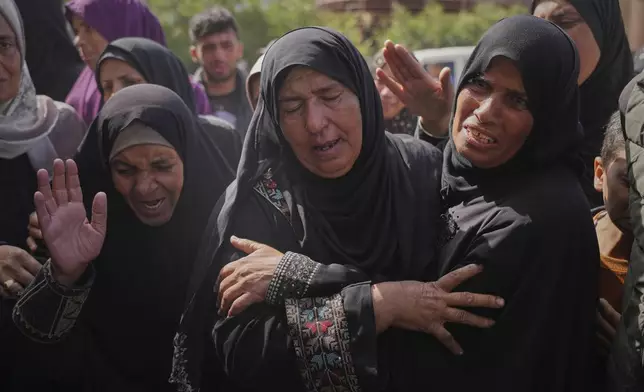 Palestinians mourn during the funeral of Reem Al-Akhras, who was killed while heading to an aid distribution hub, in Khan Younis, Gaza Strip, Tuesday, June 3, 2025. (AP Photo/Abdel Kareem Hana)