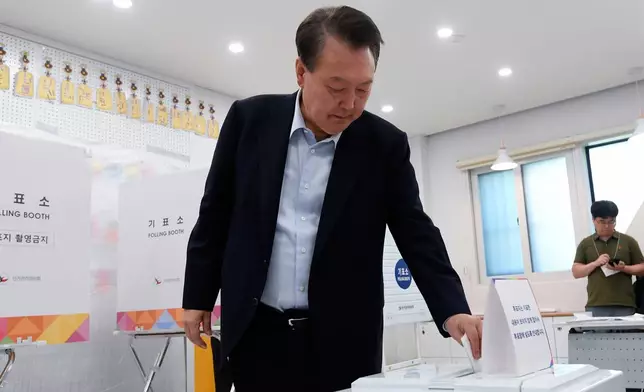 Former South Korean President Yoon Suk Yeol casts his vote for the presidential election at a polling station in Seoul, South Korea, Tuesday, June 3, 2025. (Korea Pool/Yonhap via AP)