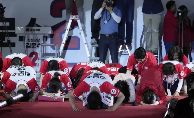 Kim Moon Soo, presidential candidate with the People Power Party, center, bows before supporters attending his election campaign rally in Seoul, South Korea, late Monday, June 2, 2025. (AP Photo/Ahn Young-joon)