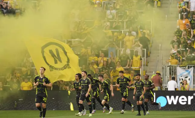 Columbus Crew forward Ibrahim Aliyu (11) celebrates with teammates after scoring during the first half of an MLS soccer match against Vancouver Whitecaps, Saturday, June 14, 2025, in Columbus, Ohio. (AP Photo/Jeff Dean)