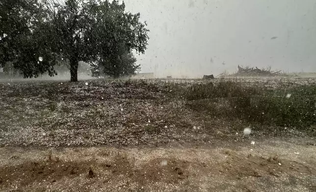A hailstorm is visible from Northern Illinois University's Husky Hail Hunter vehicle during a Project ICECHIP operation Friday, June 6, 2025, in Levelland, Texas. (AP Photo/Carolyn Kaster)