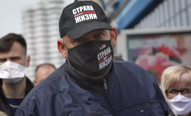 FILE - Blogger Siarhei Tsikhanouski, wearing a face mask to protect against coronavirus, speaks to people gathered to sign up and support potential presidential candidates in the upcoming presidential elections in Minsk, Belarus, Sunday, May 24, 2020. (AP Photo, File)