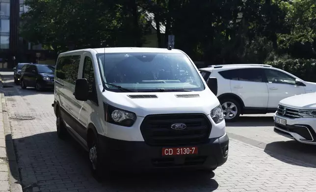 A car carrying released Belarusian dissidents arrives at the US Embassy in Vilnius, Lithuania, Saturday, June 21, 2025 (AP Photo/Mindaugas Kulbis)