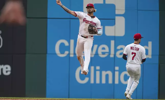 Cleveland Guardians' Gabriel Arias throws out Houston Astros' Victor Caratini as Will Wilson (7) avoids the play during the ninth inning of a baseball game, Saturday June 7, 2025, in Cleveland. (AP Photo/Phil Long)