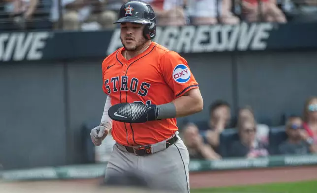 Houston Astros' Yainer Diaz scores on an RBI single by Jeremy Pena during the fifth inning of a baseball game, Saturday June 7, 2025, in Cleveland. (AP Photo/Phil Long)