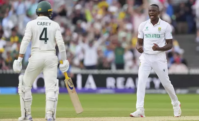 South Africa's Kagiso Rabada, right, celebrates the dismissal of Australia's Alex Carey, left, on day two of the World Test Championship final between South Africa and Australia at Lord's cricket ground in London, Thursday, June 12, 2025. (AP Photo/Kirsty Wigglesworth)