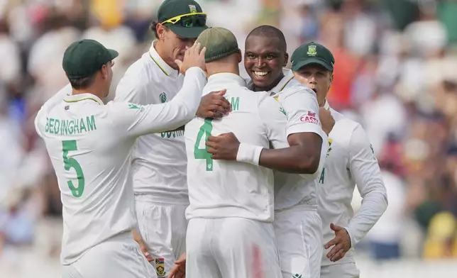 South Africa's Lungi Ngidi, second right, celebrates with teammates the dismissal of Australia's captain Pat Cummins on day two of the World Test Championship final between South Africa and Australia at Lord's cricket ground in London, Thursday, June 12, 2025. (AP Photo/Kirsty Wigglesworth)