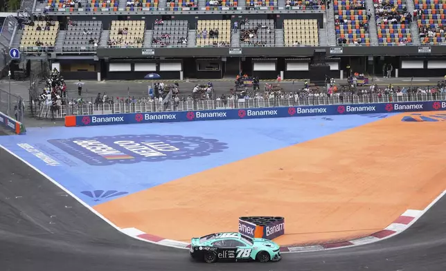 Katherine Legge drives during a qualifying session for the NASCAR Cup Series auto race at Hermanos Rodriguez race track in Mexico City, Saturday, June 14, 2025. (AP Photo/Fernando Llano)
