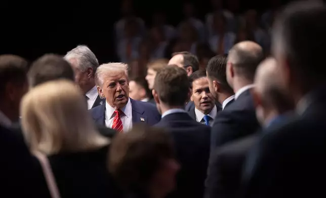 U.S. President Donald Trump, left, and U.S. Secretary of State Marco Rubio arrive before the start of a plenary session of the NATO summit of heads of state and government in The Hague, Netherlands, Wednesday, June 25, 2025. (Brendan Smialowski/Pool Photo via AP)