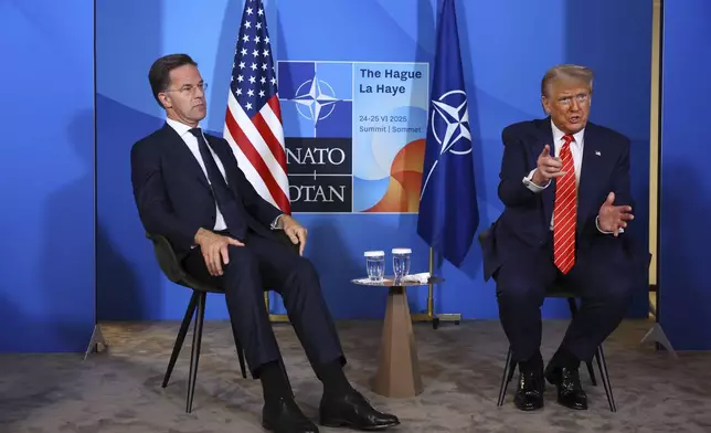 President Donald Trump, right, speaks during a meeting with NATO Secretary General Mark Rutte as he arrives for a NATO summit in The Hague, Netherlands, Wednesday, June 25, 2025. (Piroschka van de Wouw, Pool Photo via AP)