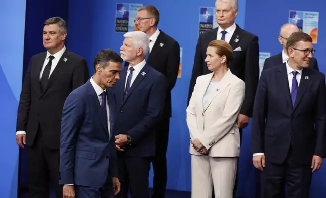 Spain's Prime Minister Pedro Sanchez, second right, arrives for a group photo with NATO heads of state and government during the NATO summit in The Hague, Netherlands, Wednesday, June 25, 2025. (AP Photo/Geert Vanden Wijngaert)