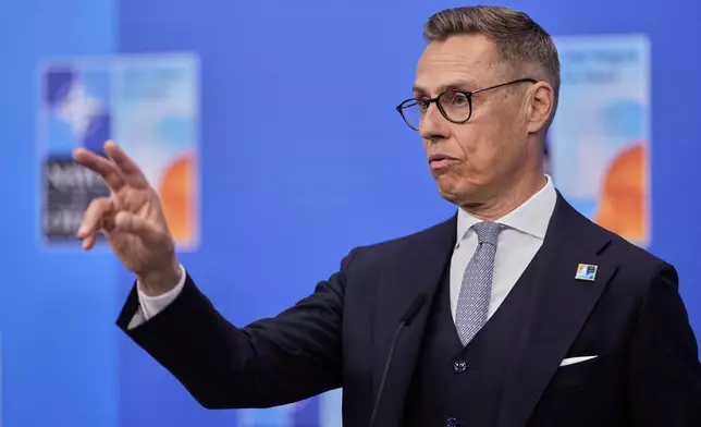Finland's President Alexander Stubb speaks with the media as he arrives for the NATO summit in The Hague, Netherlands, Wednesday, June 25, 2025. (AP Photo/Matthias Schrader)