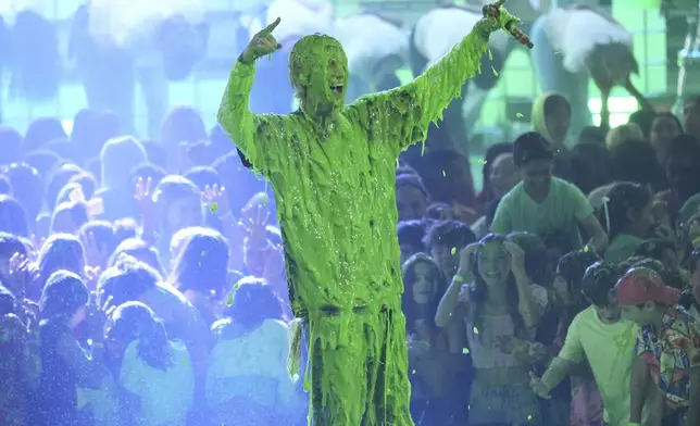 Machine Gun Kelly gets slimed after performing "Cliche" during the Nickelodeon Kids' Choice Awards on Saturday, June 21, 2025, at The Barker Hangar in Santa Monica, Calif. (AP Photo/Chris Pizzello)