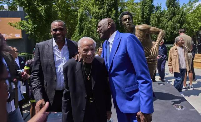Former NBA basketball player and coach Lenny Wilkens, center, poses for a photo with former NBA players Steve Smith, left, and Spencer Haywood, right, after an unveiling for a statue of Wilkens outside of Climate Pledge Arena, Saturday, June 28, 2025, in Seattle. (AP Photo/Lindsey Wasson)
