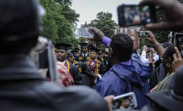 FILE - The Morehouse College graduating class makes its way past past camera phones as it arrives for commencement during graduation ceremony held at the campus on May 18, 2014, in Atlanta. (John Amis/Atlanta Journal-Constitution via AP, file)