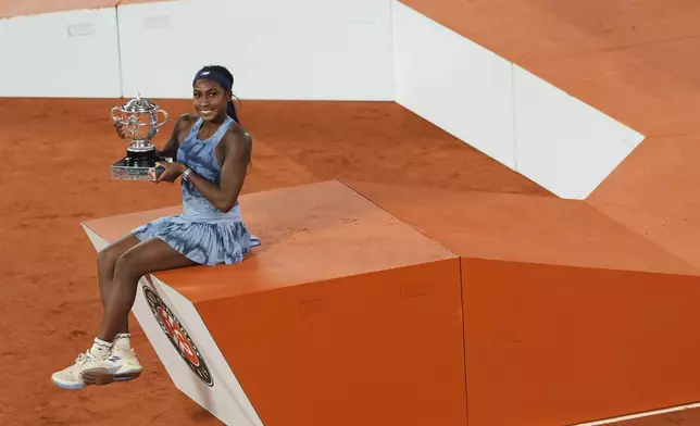 Coco Gauff of the U.S. poses with the trophy after winning the final match of the French Tennis Open against Aryna Sabalenka of Belarus at the Roland-Garros stadium in Paris, Saturday, June 7, 2025. (AP Photo/Lindsey Wasson)