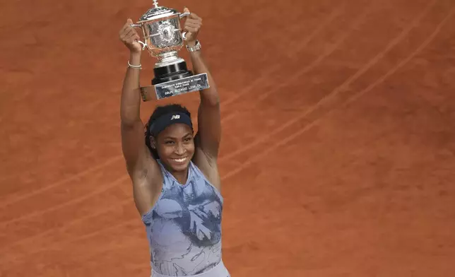 Winner Coco Gauff of the U.S. celebrates with the trophy after the final match of the French Tennis Open against Aryna Sabalenka of Belarus at the Roland-Garros stadium in Paris, Saturday, June 7, 2025. (AP Photo/Christophe Ena)