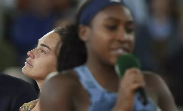 Aryna Sabalenka of Belarus looks up as Coco Gauff of the U.S delivers a speech after winning their final match of the French Tennis Open at the Roland-Garros stadium in Paris, Saturday, June 7, 2025. (AP Photo/Thibault Camus)