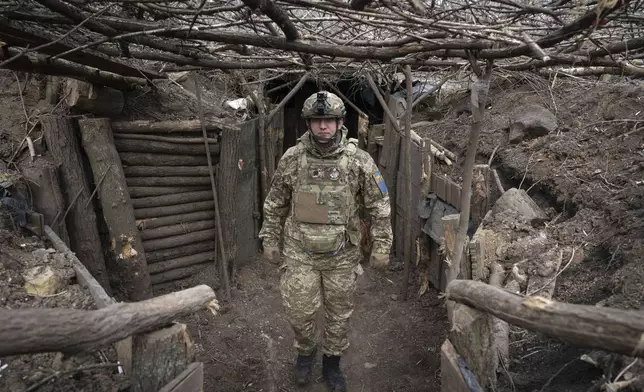 FILE - A Ukrainian serviceman of the 28th Separate Mechanised Brigade stands in a trench at the front line, near Bakhmut, Donetsk region, Ukraine, March 3, 2024. (AP Photo/Efrem Lukatsky, File)