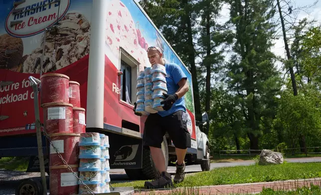 Hershey's Ice Cream delivery driver Sam Sattazahn delivers ice cream to Pine Grove Furnace general store, home of the half-gallon ice cream challenge, at Pine Grove Furnace State Park in Pennsylvania on Tuesday, June 10, 2025.(AP Photo/Mingson Lau)